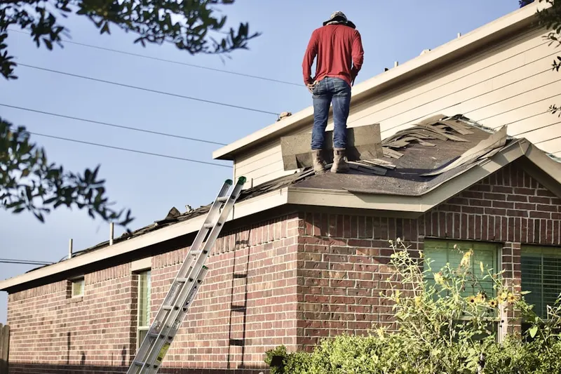 Professional roofer working on a residential roof in The Villages of Palm Beach Lakes